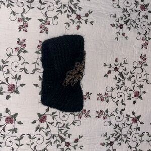 Black knitted headband with beaded design on front